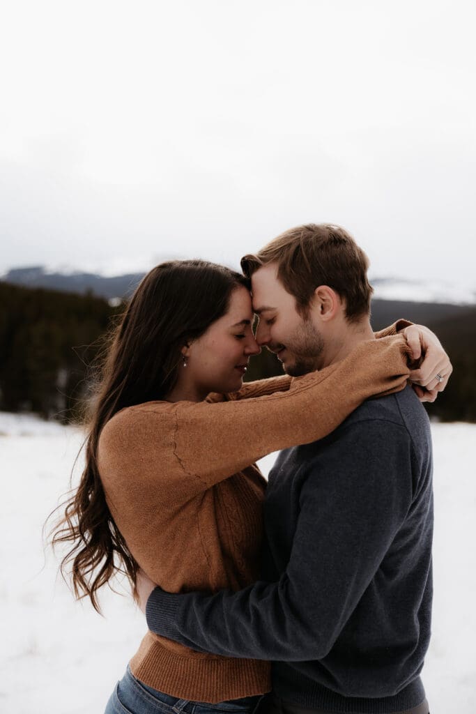 Photograph of engagement session in the Big Horn Mountains where the couple are embracing each other.