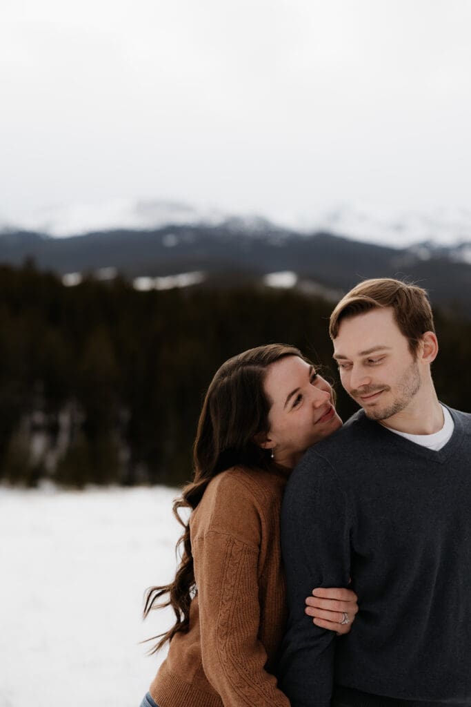 Photograph of engagement session in the Big Horn Mountains where the couple are looking at each other.