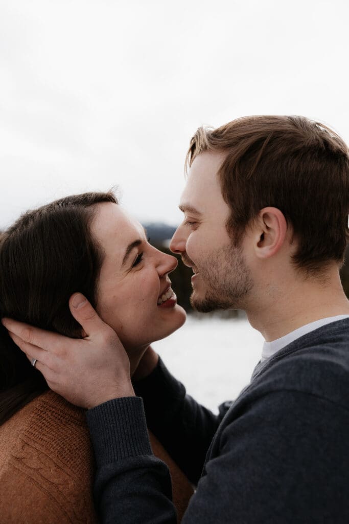 Photograph of engagement session in the Big Horn Mountains where the couple are smiling at each other.