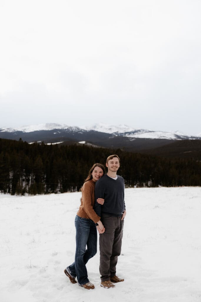Photograph of engagement session in the Big Horn Mountains where the couple are smiling at the camera.